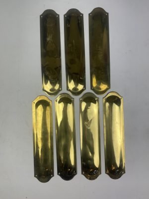 Set of seven brass finger plates
